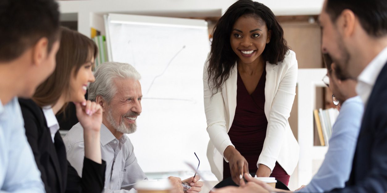 African American Woman presenting to a group of professionals