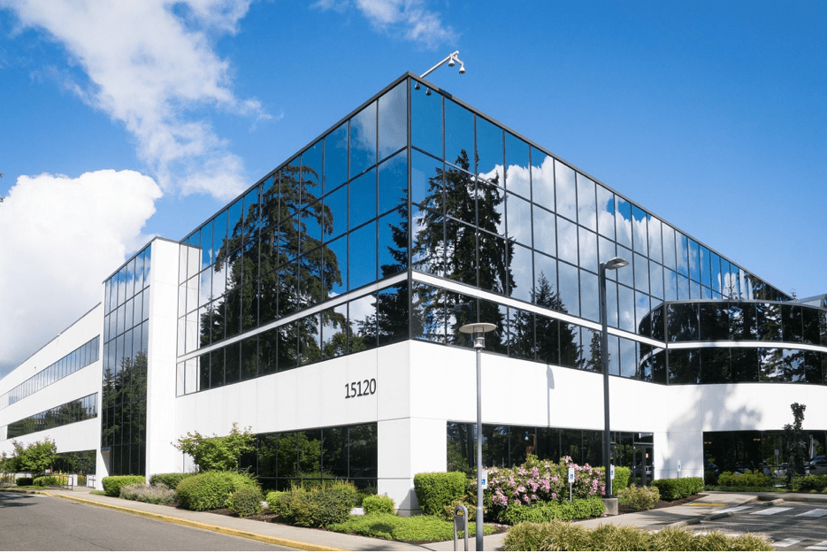 Commercial real estate example of a glass building on a sunny day