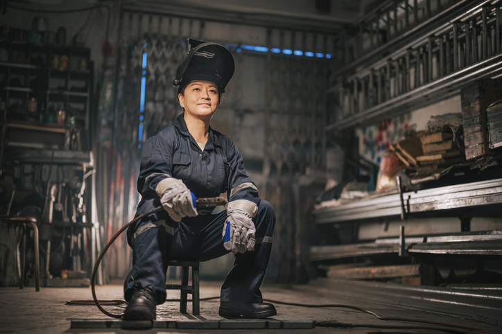 Woman-owned business, manufacturing contractor smiling proudly