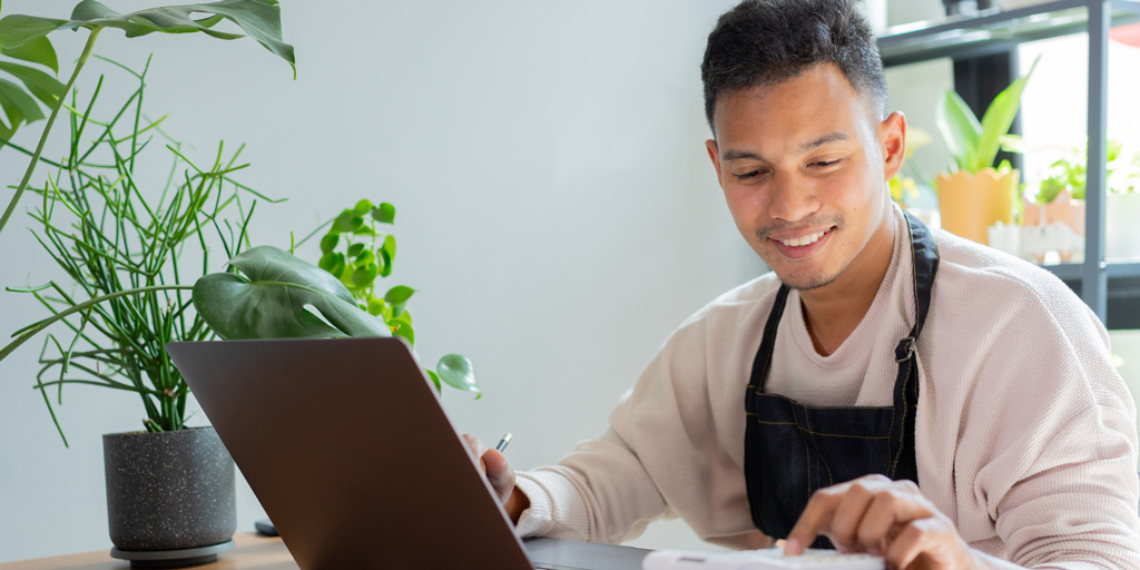 Close up young business owner press on calculator to checking and summary profit of order for entrepreneur and financial concept