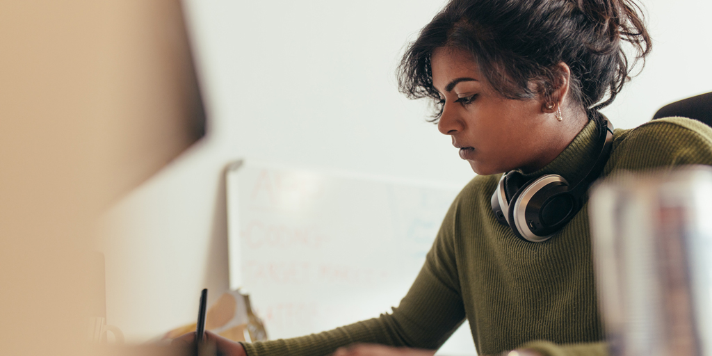 Female computer programmer working at her desk