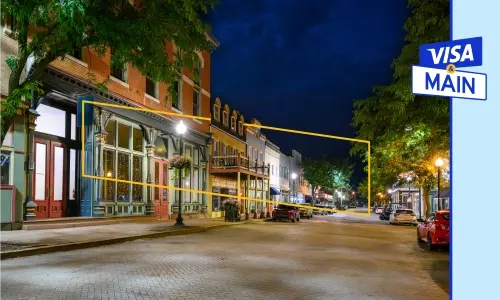 VISA & Main Ad Banner showing a quite night on an lighted empty street and VISA & Main logo in the top right corner