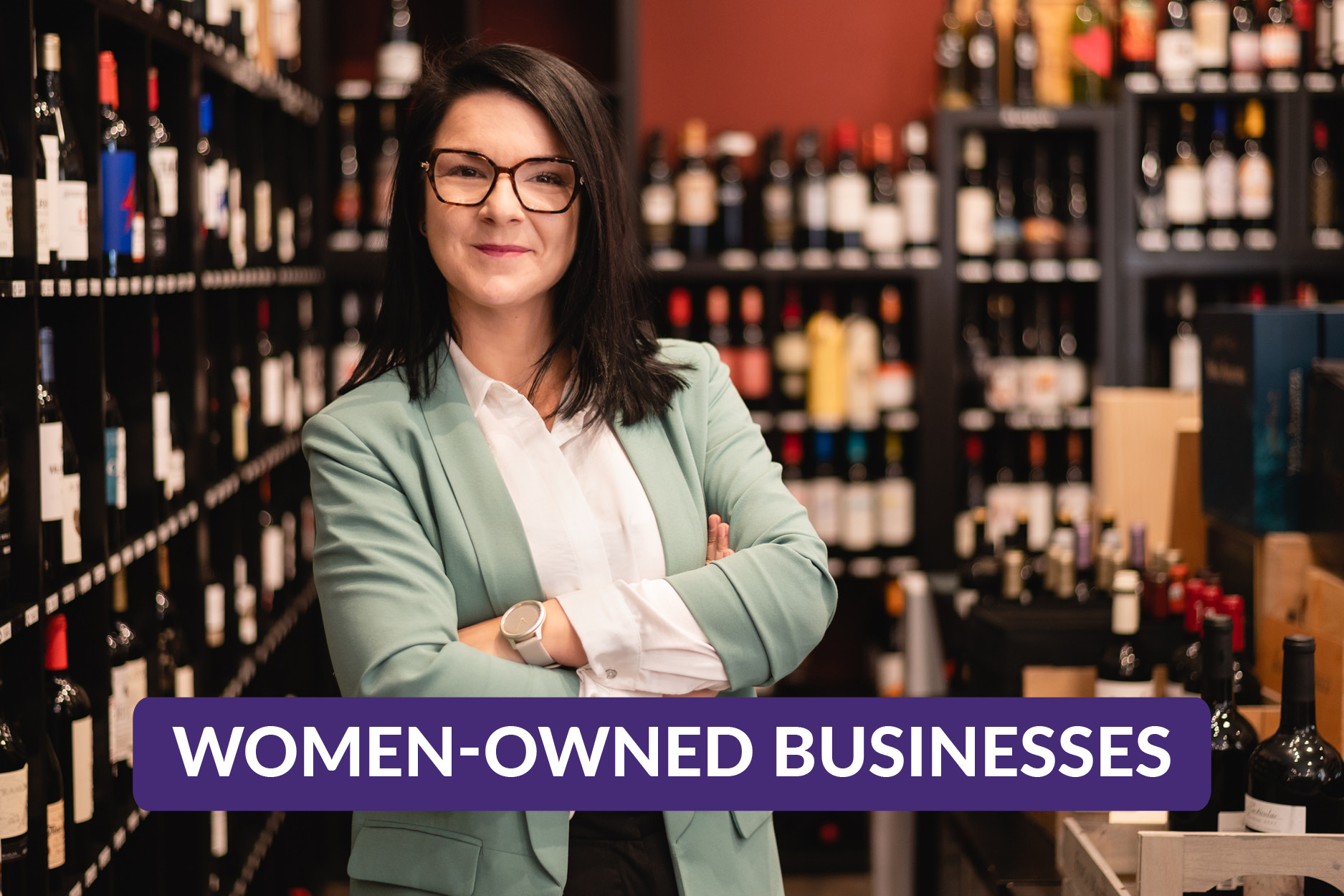 Female business owner arms crossed standing proudly in her shop