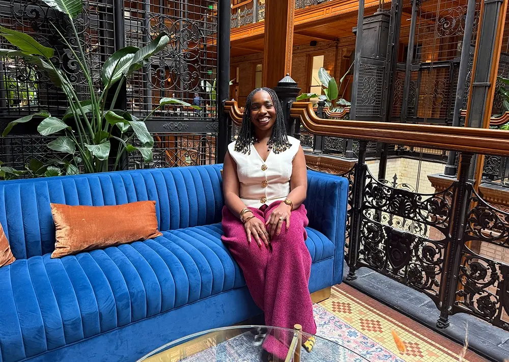 Ezinne Price of Grid110 sitting on blue couch
